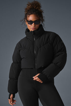 Main Act Corset Puffer jacket in black featuring a cropped silhouette and corset hemline, perfect for chilly days.