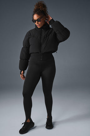 Main Act Corset Puffer jacket featuring cropped silhouette and warm lightweight design with stylish leggings.