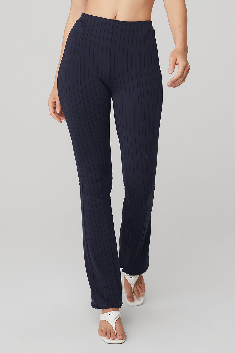 High-waist pinstripe zip it flare legging in navy blue, featuring a skinny waistband and invisible zippers for adjustable flares.