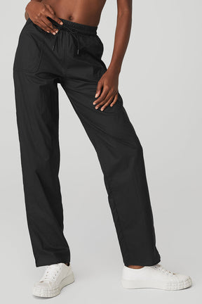 Black Cloud Nine Pant featuring a high-waist design, drawcord, and zippered pockets for a stylish and comfortable look.