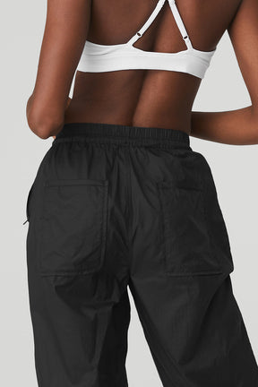 Back view of a model wearing Cloud Nine Pant featuring zippered pockets and a high-waist design.