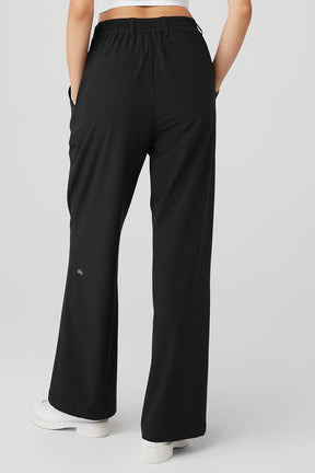 High-waist pursuit trouser featuring a relaxed wide-leg fit and stretchy waistband, perfect for work and weekend wear.