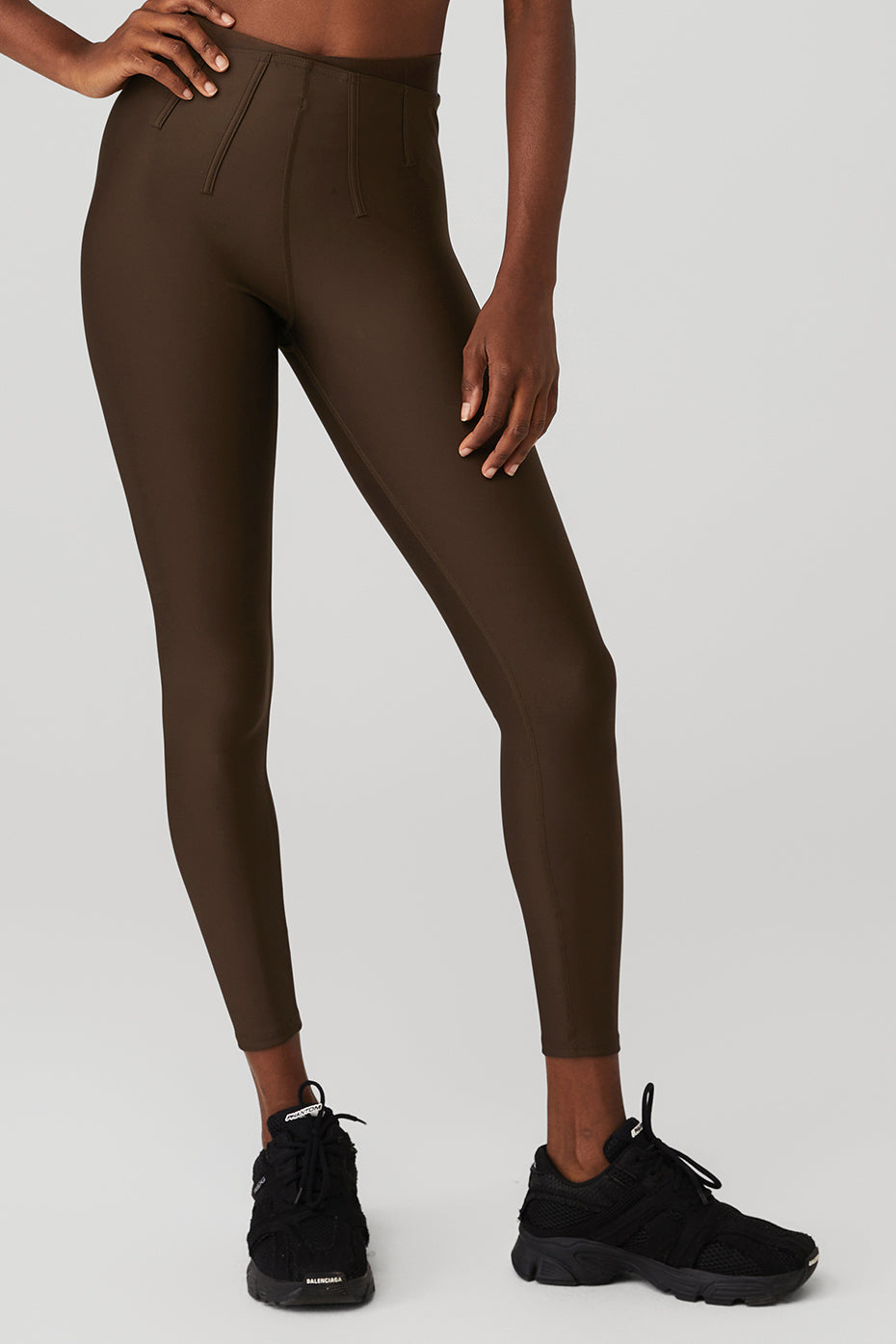 Airlift High-Waist 7/8 Corset Legging in brown with sculpting details, worn with black sneakers, ideal for activewear.