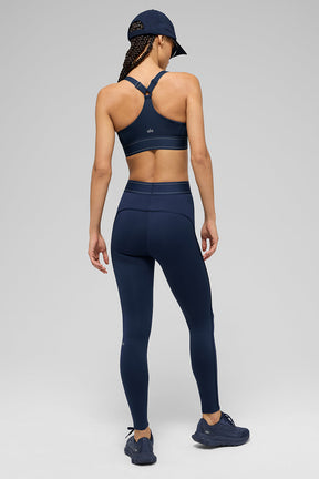 Model wearing Airlift high-waist Suit Up leggings with matching sports bra, showcasing boxer-style waistband and full-length fit.