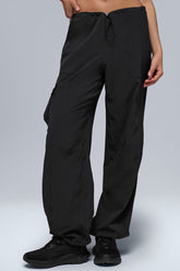 Megastar Cargo Pant in black with adjustable waist and hem, featuring a modern baggy fit and sleek performance fabric.