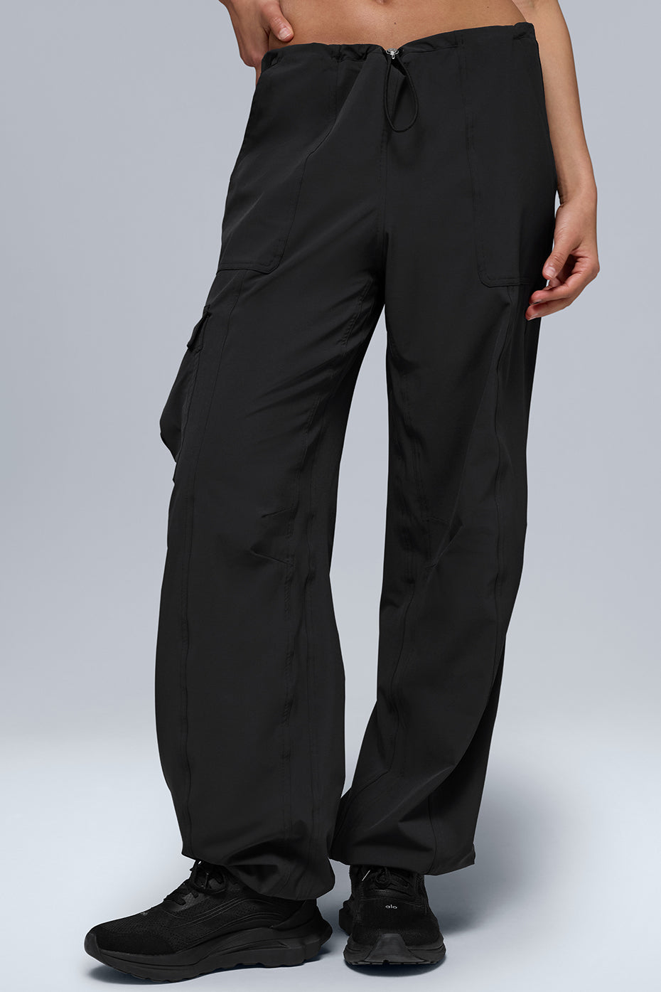 Megastar Cargo Pant in black with adjustable waist and hem, featuring a modern baggy fit and sleek performance fabric.