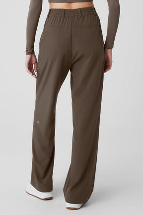 Back view of high-waist pursuit trousers showcasing relaxed wide-leg fit and stretchy waistband.