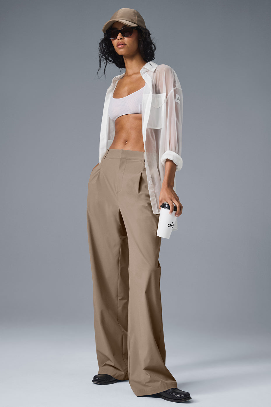 Model wearing high-waist pursuit trousers long version with a relaxed fit and tailored details in a stylish setting.