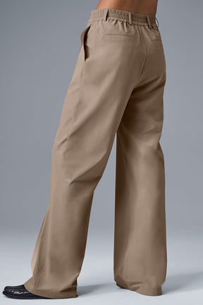 High-waist pursuit trouser in tan, showcasing wide-leg fit and relaxed style for modern everyday wear.