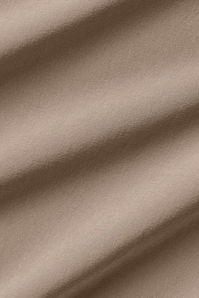 Close-up of lightweight stretch-infused fabric in soft neutral tone, ideal for modern fit high-waist trousers.