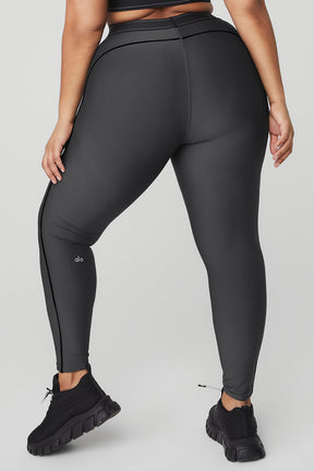A woman wearing Airlift High-Waist Suit Up Legging with body-contouring piping and boxer-style waistband from the back.