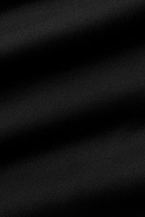 Close-up of soft black fabric ideal for leggings, showcasing the sleek texture and high-quality material.