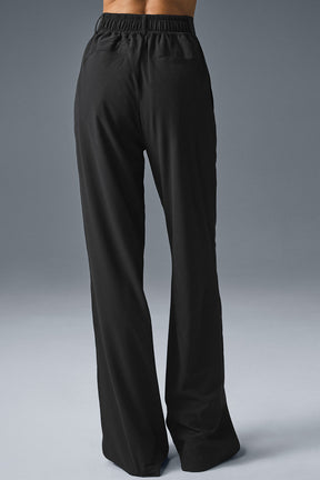 Back view of High-Waist Dreamscape Trouser in black, featuring a relaxed fit and lightweight crinkle woven fabric.