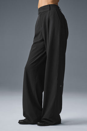 High-waist Dreamscape Trouser in black, featuring a pleated design and lightweight crinkle woven fabric.