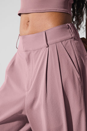 Close-up of High-Waist Dreamscape Trouser showcasing pleats and crinkle fabric in a soft pink color.