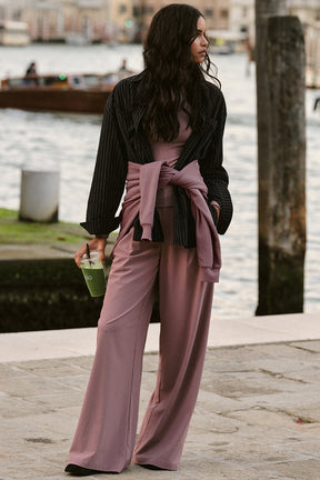 Model showcasing the High-Waist Dreamscape Trouser in a stylish outfit by the waterfront.