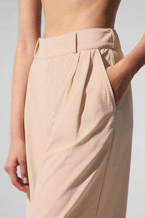 Close-up of High-Waist Dreamscape Trouser showcasing pleats and pockets in lightweight fabric.