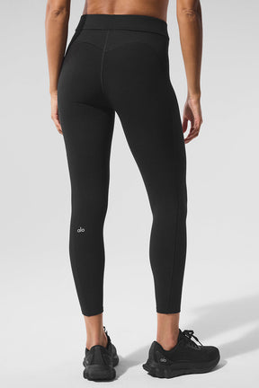 Back view of a woman wearing Alosoft High-Waist 7/8 Relay Legging, showcasing the sleek design and logo waistband.