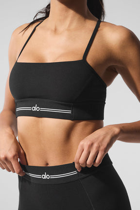 Model wearing Alosoft Relay Bra paired with high-waist Relay Legging showcasing sleek ribbing details.