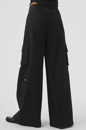 Back view of Show Off Cargo Wide Leg Trouser in black with exaggerated wide legs and cargo pockets.