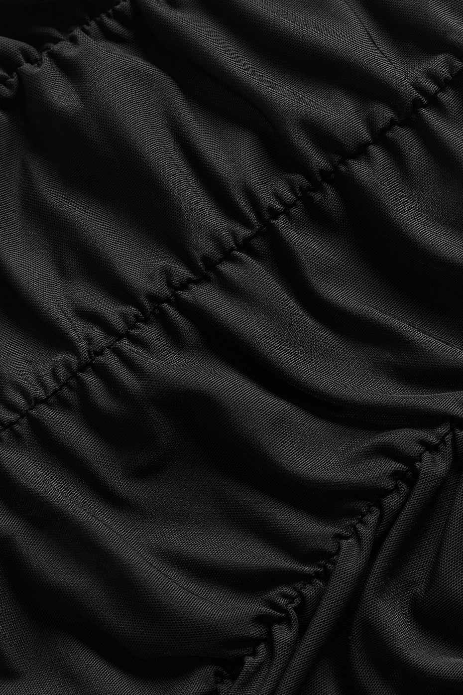 Close-up of the textured fabric of a black Airlift Mesh High-Waist Cherish Legging with gathered details.