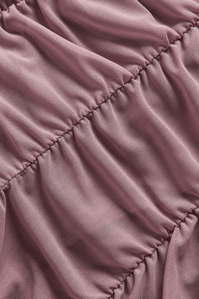 Close-up view of Airlift Mesh High-Waist Cherish Legging fabric, showcasing its ruched texture in a soft pink hue.