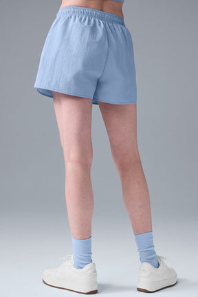 Back view of Alumni Short in light blue, featuring a high-waist design and lightweight fabric, perfect for hiking and exploring.