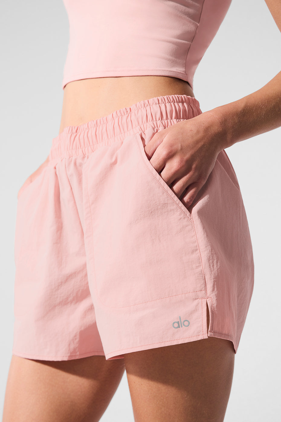 Alumni Short in light pink, featuring high-waist design, internal drawcord, and side pockets for essentials.