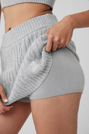 Cozy Cable Knit Winter Bliss Mini Skirt in gray being adjusted, showcasing soft fabric and elastic waistband.