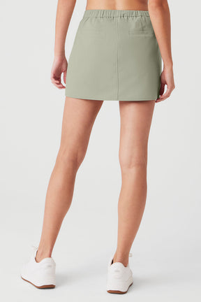 Back view of High Speed Mini Skirt featuring a stretchy elastic waist and tailored fit in soft green fabric.