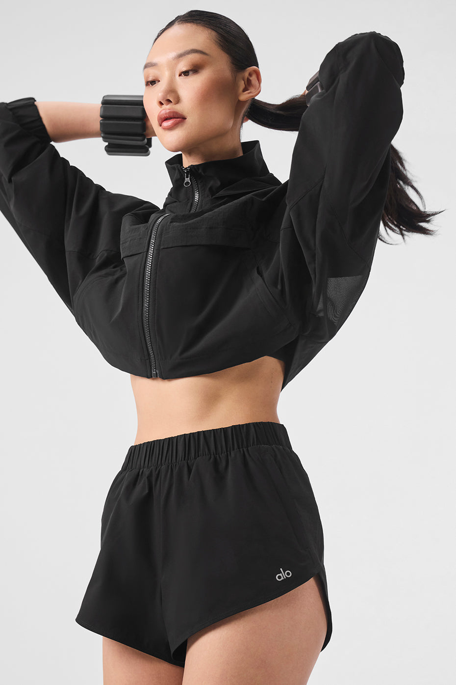 Model wearing Playmaker Dolphin Shorts with sporty black jacket showcasing elastic waistband and stylish design.