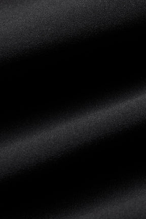 Close-up of textured black fabric used in Playmaker Dolphin Short, showcasing its sporty and stretchy qualities.