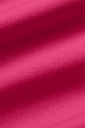 Close-up of vibrant pink fabric showcasing a soft, slightly stretchy texture ideal for sporty shorts.