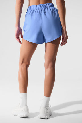 Back view of Playmaker Dolphin Shorts in blue with elastic waist and sporty design, showcasing ripstop panels.