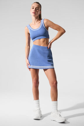 Model wearing Tennis Club sweater knit skirt and matching bra with collegiate stripes, perfect for Padel games.