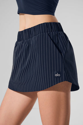 Pinstripe Daylight Mini Skirt featuring built-in shorts and lightweight structure for sunny days and chic evenings.