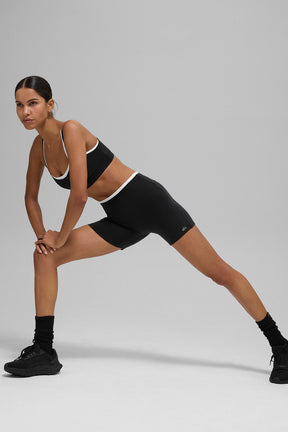 Model wearing 5" Airbrush Double Up Short and matching bra, demonstrating flexibility and comfort in a chic athletic style.