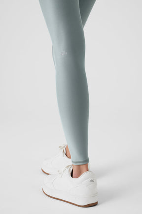 Airlift Winter Warm High-Waist Legging in light blue, paired with white sneakers, showcasing a second-skin fit.