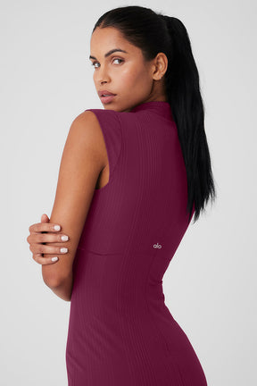 Model wearing a sleeveless mock neck Run It Back Dress in burgundy, showcasing its ribbed design and flattering fit.