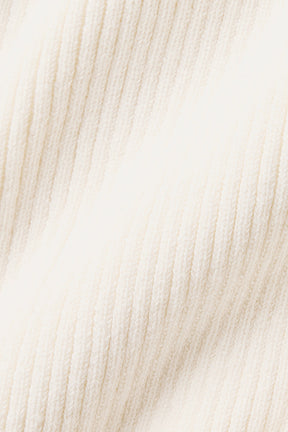 Close-up of lightweight knit fabric in creamy white, ideal for a Supernatural Sweater Dress, offering breathability and style.