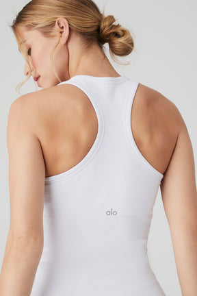 Woman wearing the Ribbed Aspire Full Length Tank showcasing the racerback design in white, highlighting its ribbed texture.