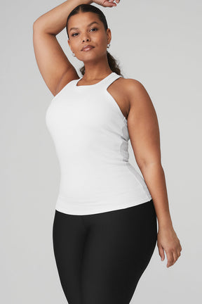 Model wearing the Ribbed Aspire Full Length Tank in white, showcasing its high-neck design and racerback style.