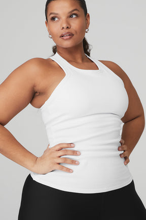 Model showcasing the Ribbed Aspire Full Length Tank in white, highlighting its high-neck and racerback design for versatile layering.