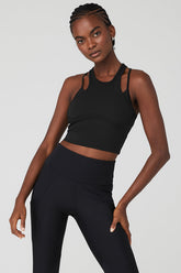 Model wearing the Ribbed Airlift Enchanted Bra Tank, showcasing adjustable straps and a stylish design.