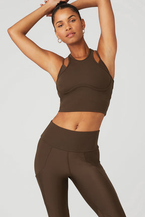 Model showcasing the Ribbed Airlift Enchanted Bra Tank in brown, paired with high-waist performance leggings.