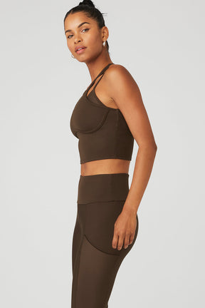 Ribbed Airlift Enchanted Bra Tank in brown, featuring double crisscross straps and flattering neckline, paired with high-waist leggings.