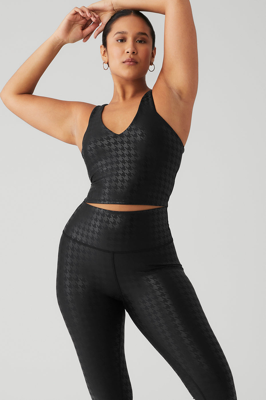 Model wearing Airlift Glimmer Houndstooth Real Bra Tank with matching leggings, showcasing sleek design and tonal houndstooth print.