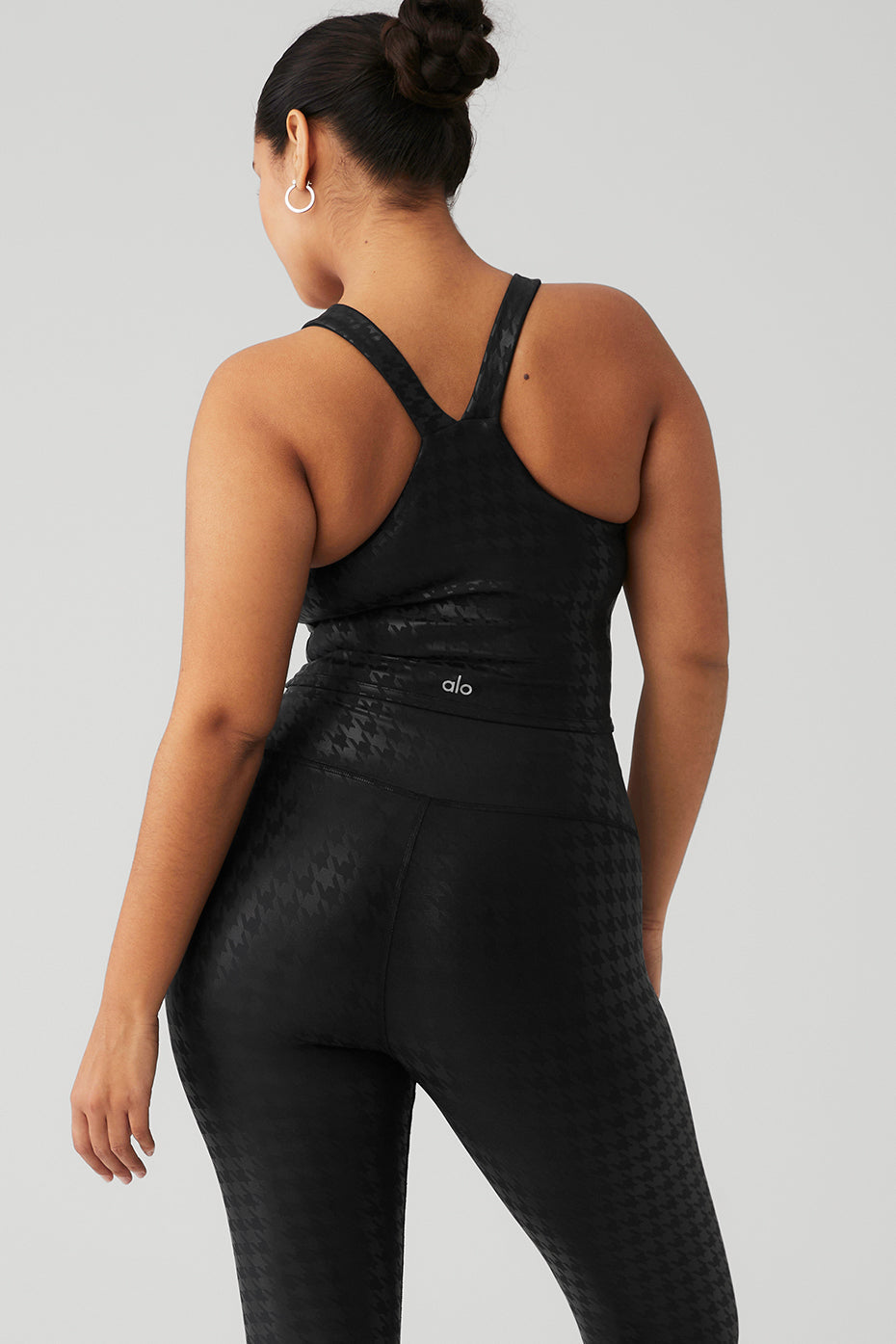 Airlift Glimmer Houndstooth Bra Tank worn with matching leggings, showcasing sleek fabric and supportive design from the back.