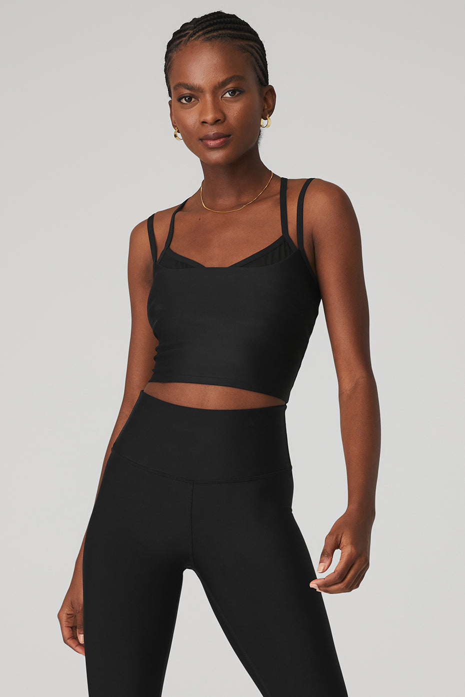 Model wearing the Airlift Double Check Bra Tank with mesh details, cropped fit, and racerback design, paired with high-waist leggings.