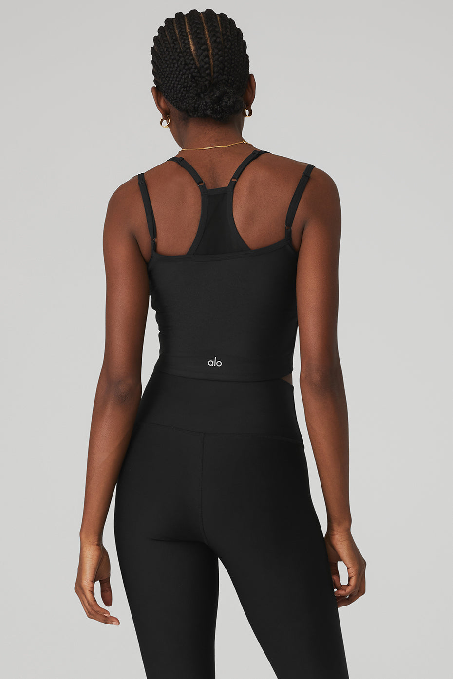 Airlift Double Check Bra Tank in black, featuring racerback design and mesh details, paired with high-waist leggings.